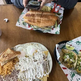 Chilaquiles Verdes (sour cream&amp; queso fresco) with Rice &amp; Beans , toast, over easy eggs .   2 Chicharron Taco - Corn   Torta milanesa