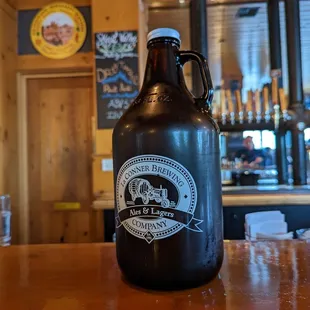 a growl of beer on a bar counter