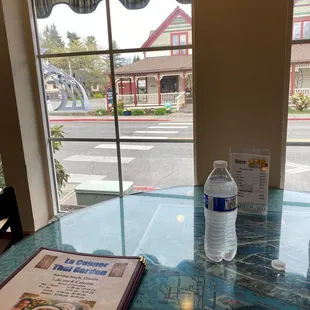 a table with a menu and water bottle