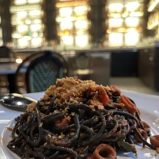 a plate of spaghetti with meat and vegetables