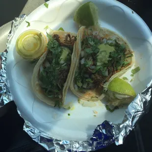 Shredded beef(desebrada) tacos. Had two fajita tacos as well but I already ate them!  The  green sauce is a nice spicy touch.