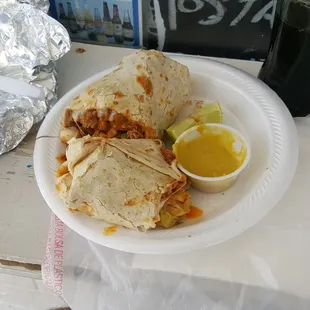 Burrito with Al Pastor and everything.  Try the creamy Salsa Verde (green sauce).  Perfect kick for chile heads.