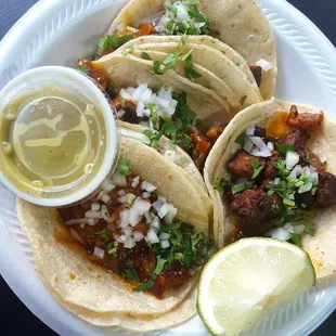 Lengua, Chicharron, and Fajita Tacos with Lime and Salsa Verde on the side