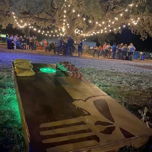 a corn hole with lights on it