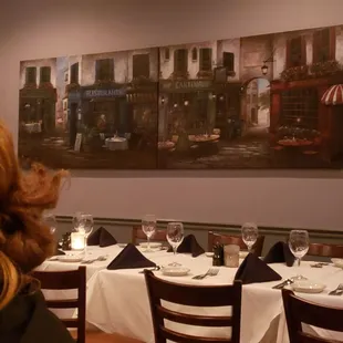 a woman sitting at a table in a restaurant