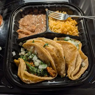 Chorizo street taco dinner with beans and rice.