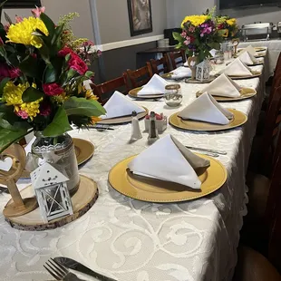 a long table set with place settings