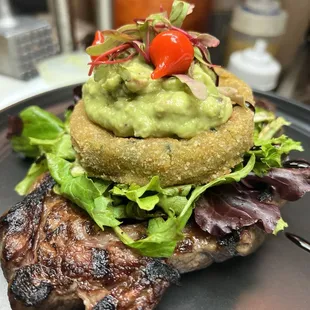 Breaded Eggplant under guacamole and Angus Bone-in Ribeye