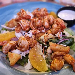 a salad with shrimp and oranges