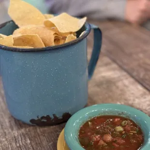 a bowl of salsa and a bowl of tortillas