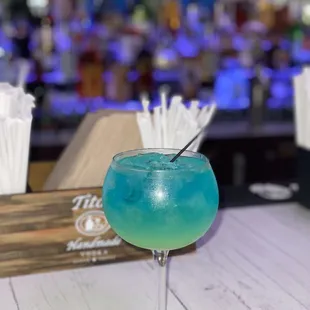 a blue drink with a straw in it