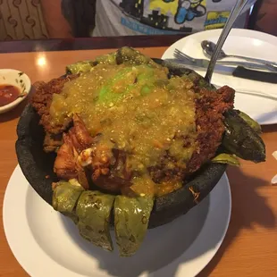 Molcajete - has chicken, carne asada, bacon wrapped shrimp,  chorizo, fried nopales, fried queso fresco. SOoO GOOD
