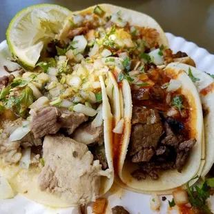 three tacos on a paper plate