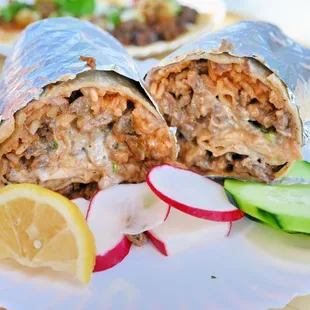 two burritos on a paper plate