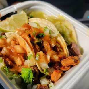 two tacos in a styrofoam container