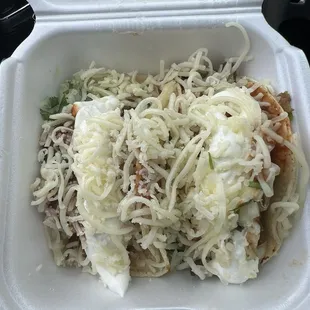 Carnitas tacos with cheese and sour cream