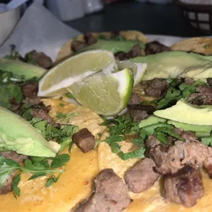 Yummy mini tacos of beef fajita with cilantro and avocado.