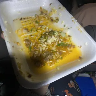 a person holding a plastic container of food