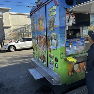 a man standing in front of a food truck
