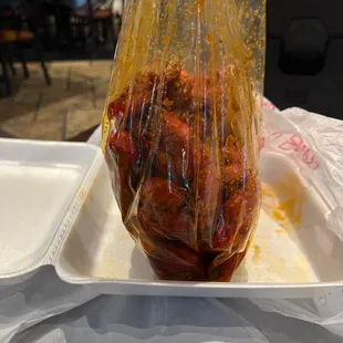 a plastic container filled with meat