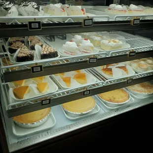 Case of more cakes, flan, bread pudding, tres leches, and templeque