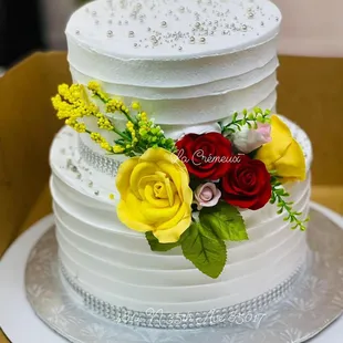 Spring Fling Cake Personalized in whipped Cream for a wedding. Gum paste Flowers