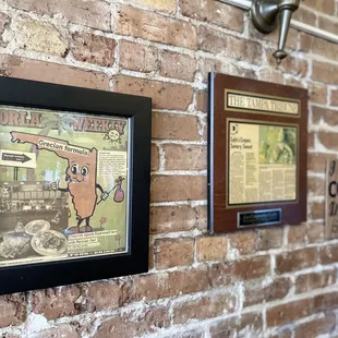 a brick wall with posters on it