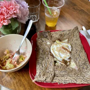 La Paris buckwheat crepe with sausage, ham, Swiss, green onions, and topped with an egg.