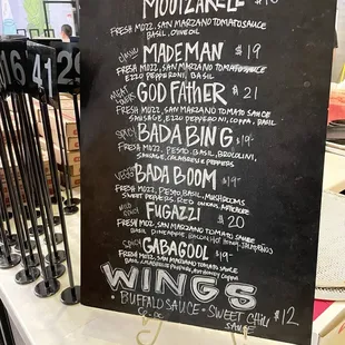 Chalk board menu on the counter. Prices circa Dec 2022.