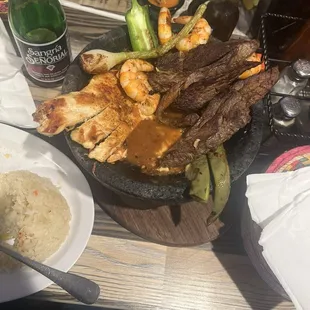 Molcajete mixto with beans and rice on the side. Delicious!!!!