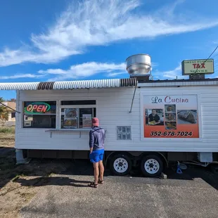 a man standing in front of a food truck