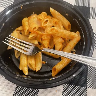 a plate of pasta and a fork