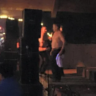 a shirtless man on stage