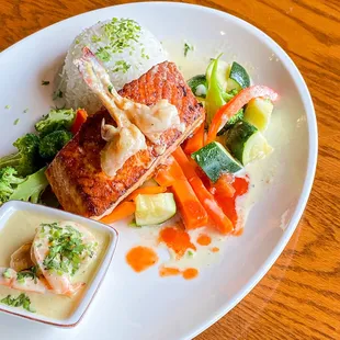 Salmon a la Pariila: Grilled Salmon served with rice and vegetables.