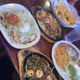Beef supreme enchiladas, queso fundido, sizzling fajitas, rice and beans w/ lettuce, guacamole, sour cream and pico de Gallo.