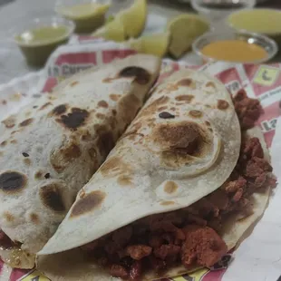 two quesadillas on a paper plate