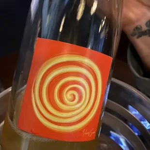 a bottle of wine with a swirl on the label