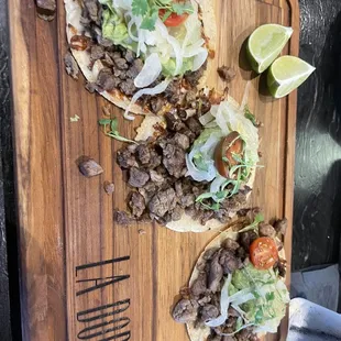 two tacos on a cutting board