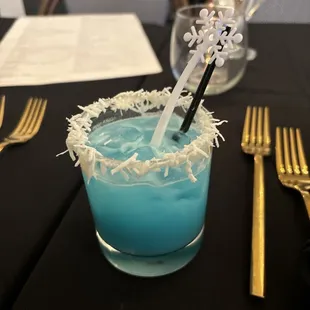 a blue drink in a glass