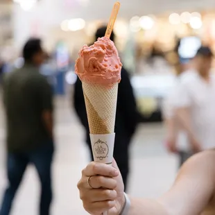 a woman holding an ice cream cone