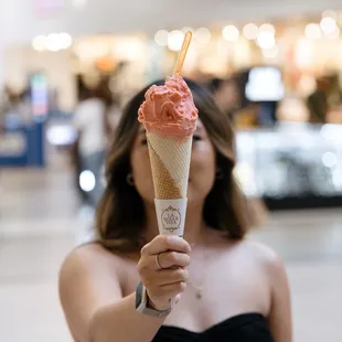 a woman holding an ice cream cone