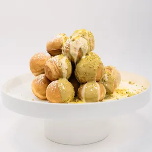 a pile of doughnuts on a white plate