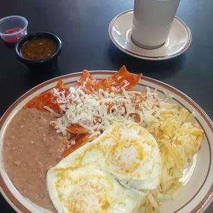 a plate of mexican food and a cup of coffee