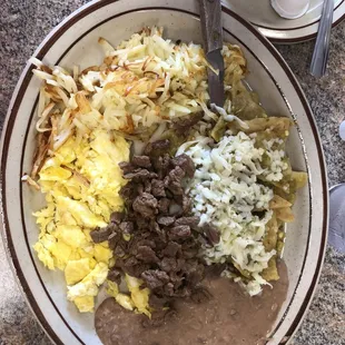 a bowl of beans, eggs, and meat