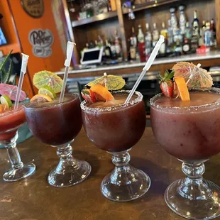 three cocktails on a bar
