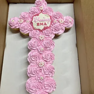 a cross shaped cake in a box