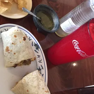 a burrito and chips on a plate
