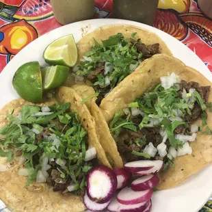 a plate of tacos and a drink