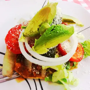 Pinto bean tostada with avocado, onions, tomato, peppers, cotija cheese, lettuce, sour cream! AMAZING