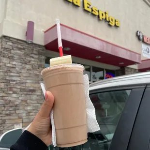 a hand holding a cup of coffee